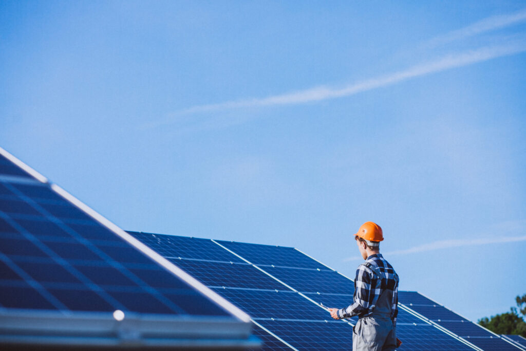 Solar technician inspecting rooftop solar panels, reflecting quality installation standards followed by the top 10 solar companies in Kerala