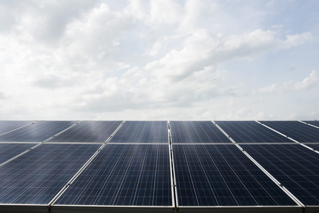 Rooftop solar panels installed on a commercial building in Kerala, showcasing how top solar companies in Kerala help businesses reduce electricity costs.