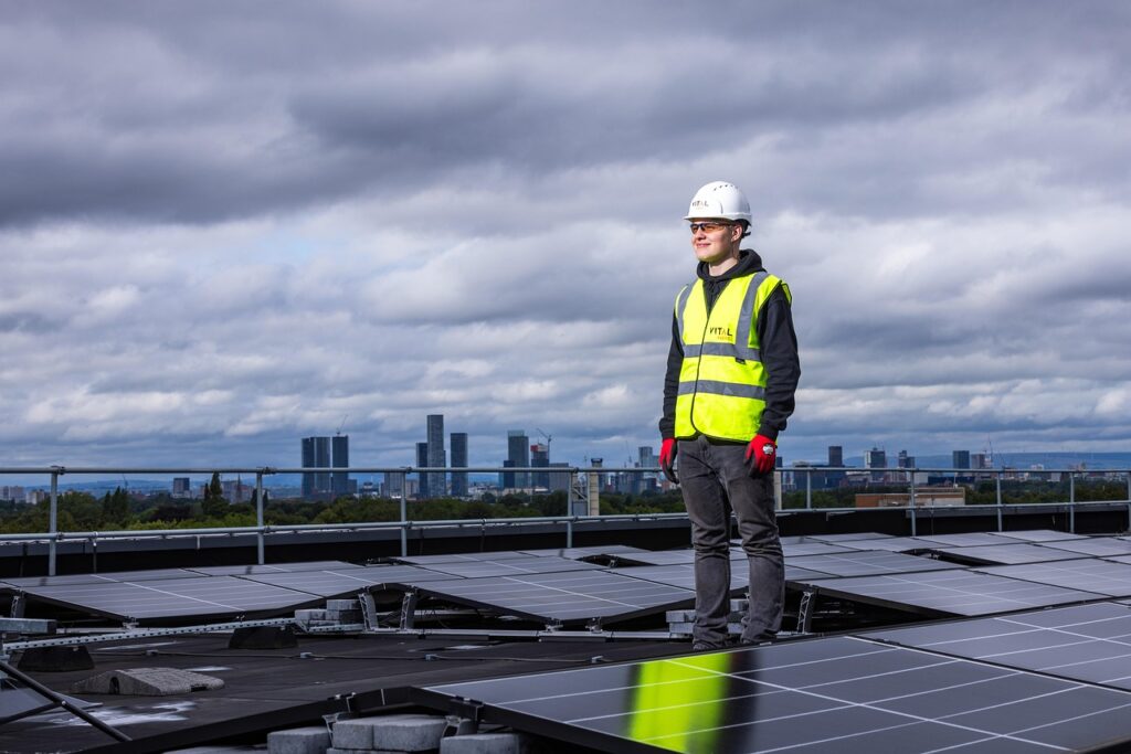 Technician inspecting rooftop solar panels installed by professional solar companies in Kerala for residential clean energy systems