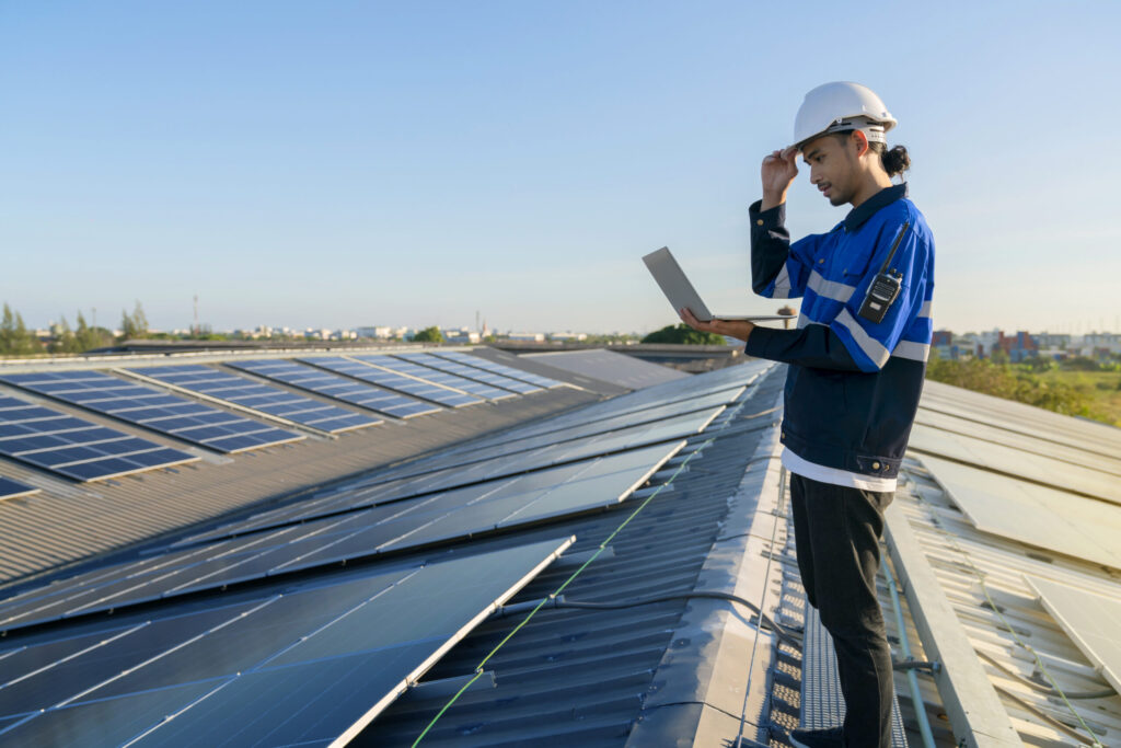 Technician inspecting rooftop installation of the best solar panels in Kerala for efficient performance and long-term maintenance