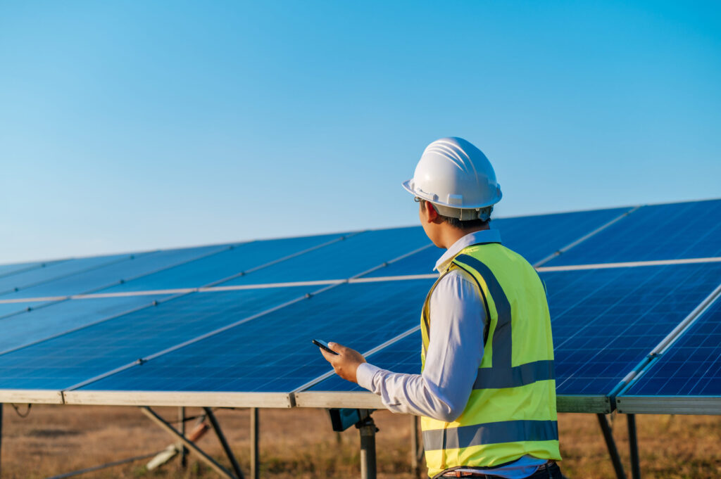 Solar engineer monitoring solar panel performance on-site, showcasing net metering services by solar companies in Kochi