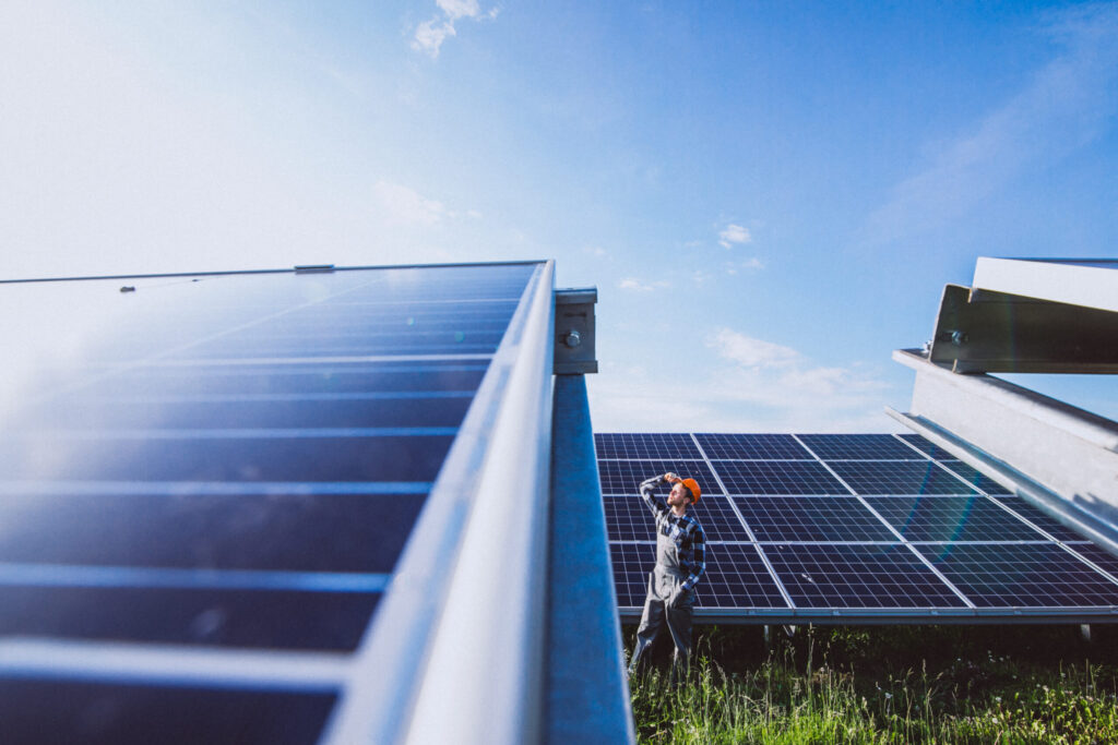 Technician inspecting solar panel installation, highlighting the quality services offered by solar companies in Calicut for efficient and reliable energy solutions.